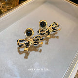 Electroplated Silver Needle Leather Wrapped Bow Earrings