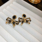 Electroplated Silver Needle Leather Wrapped Bow Earrings