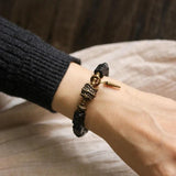 Ebony Beads Bracelet with Brass Charm