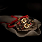 Sterling Silver Red Rope Bracelet with Peace Buckle Knots