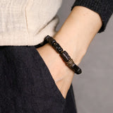 Hand Carved Ebony Bracelet with Unique Brass Charm