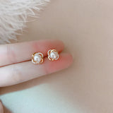 Elegant 14k Twist Stud Earrings with Zircon and Pearl