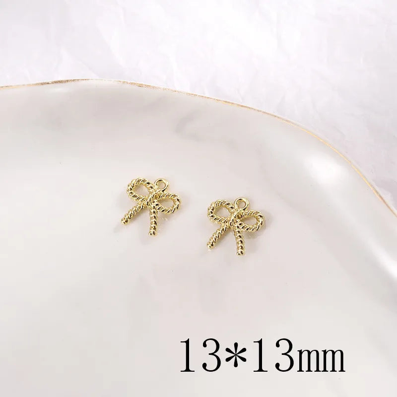 100pcs 13mm Spray Paint Cartoon Bow Alloy Charms DIY Earring Pendant Accessory